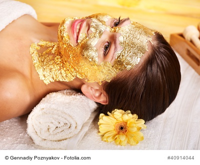 Woman getting facial mask .